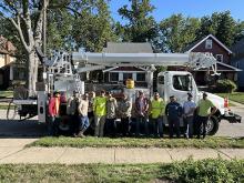 Crews from Orville, Hudson and Wadsworth power line up in front of a line truck